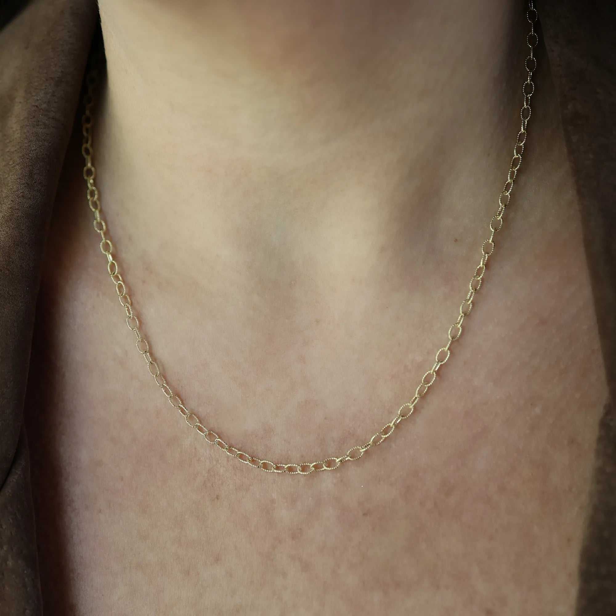 14k yellow gold textured oval link chain necklace worn on neck, dainty gold chain necklace, minimalist layered necklace, everyday fine jewelry