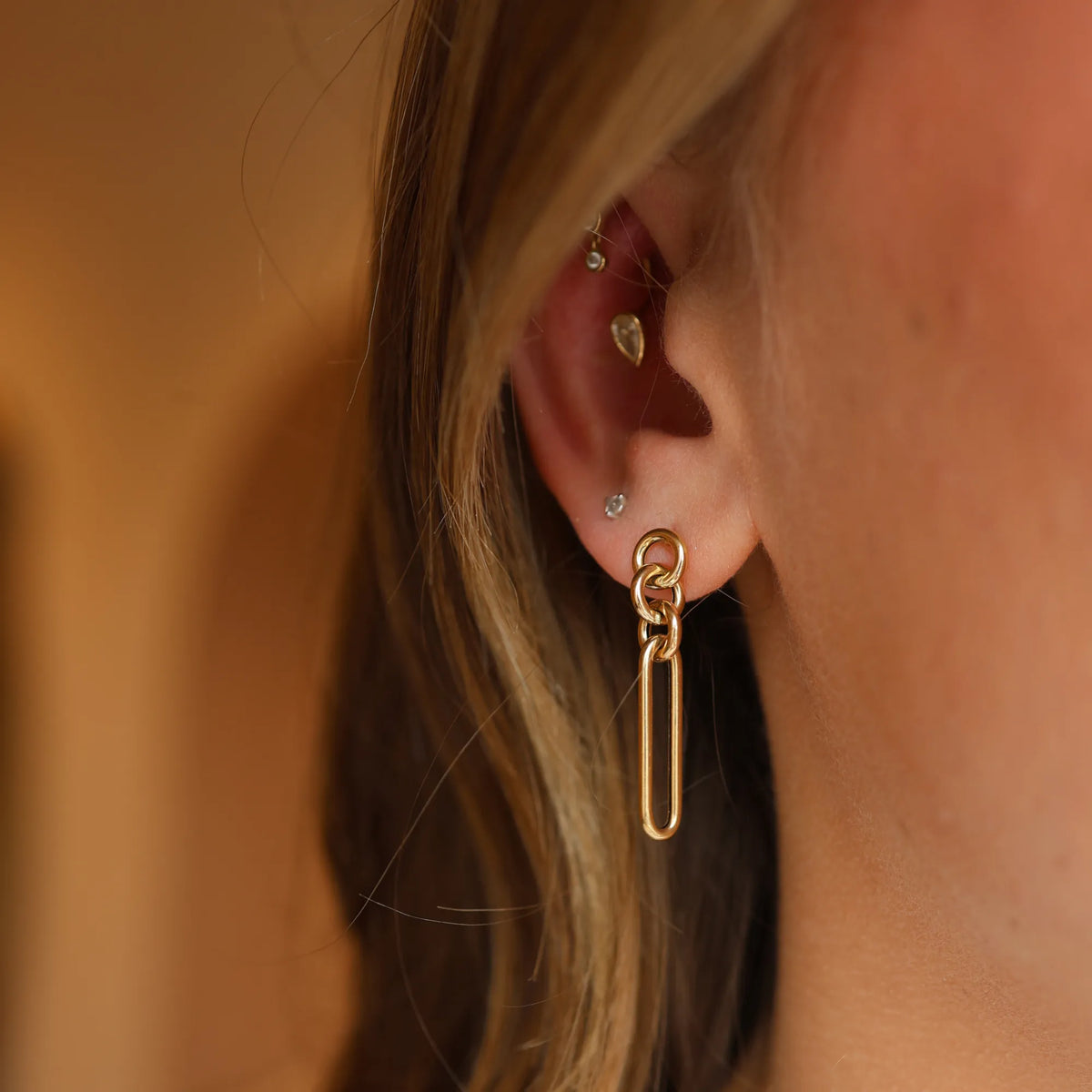 14k yellow gold mixed link drop earrings worn on the ear, sculptural chain link statement earrings from Mama Bijoux fine jewelry, Costa Mesa California