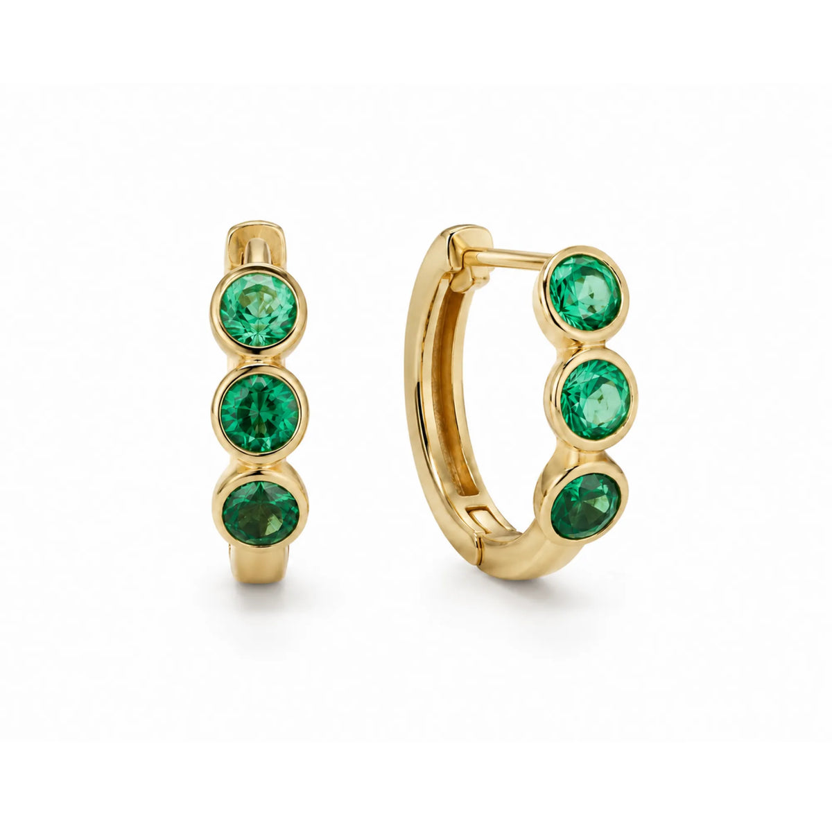 14k yellow gold huggie hoop earrings with round lab grown emerald bezels, flatlay on white background, Mama Bijoux Costa Mesa Orange County fine jewelry