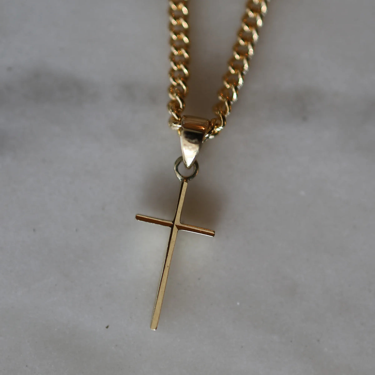 14k yellow gold dainty cross charm necklace flatlay on chain, handmade jewelry by Mama Bijoux Costa Mesa Orange County