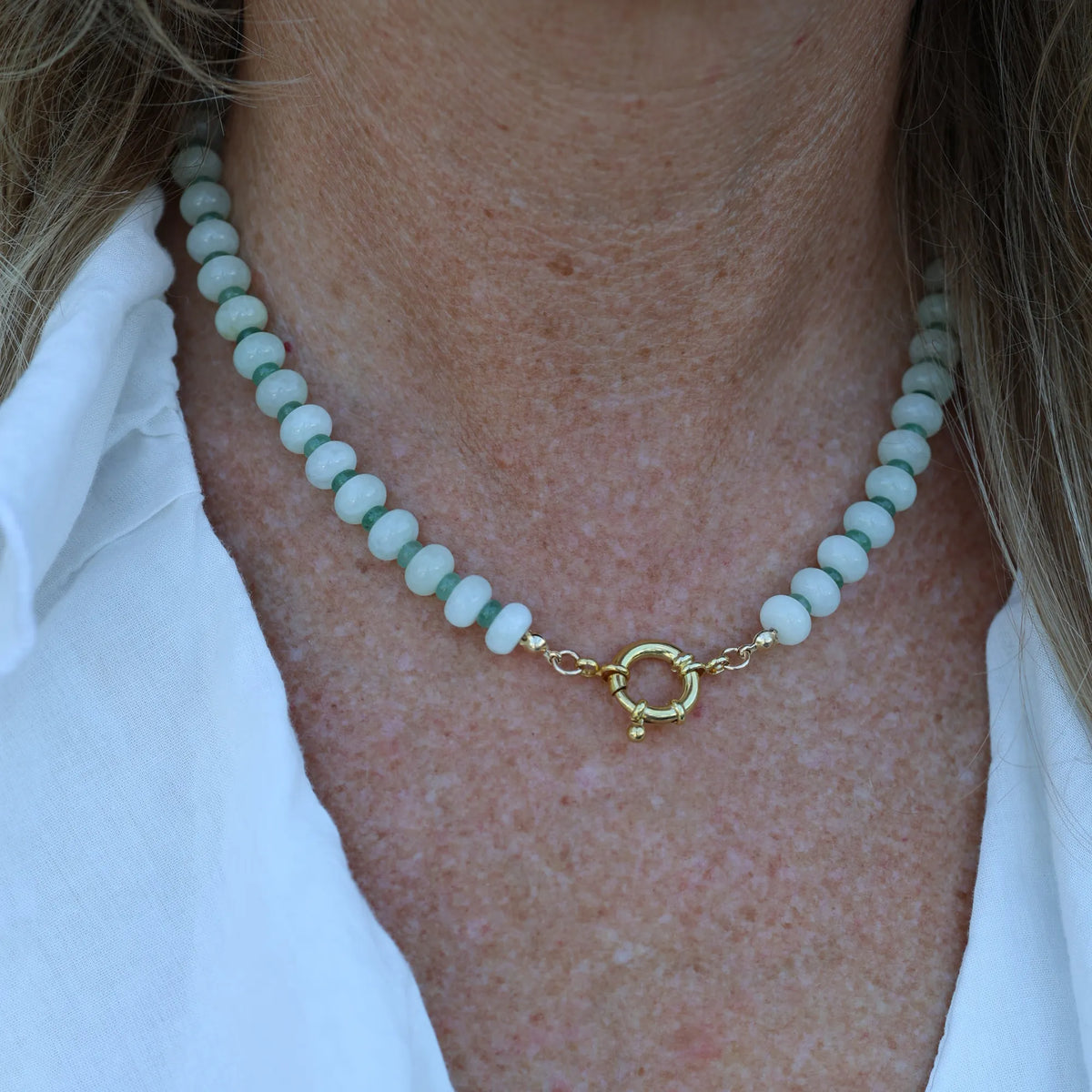 Woman wearing the Seafoam Dream prehnite beaded necklace by Mama Bijoux x Isla Sol with natural prehnite gemstones, green aventurine accents, and gold filled details.