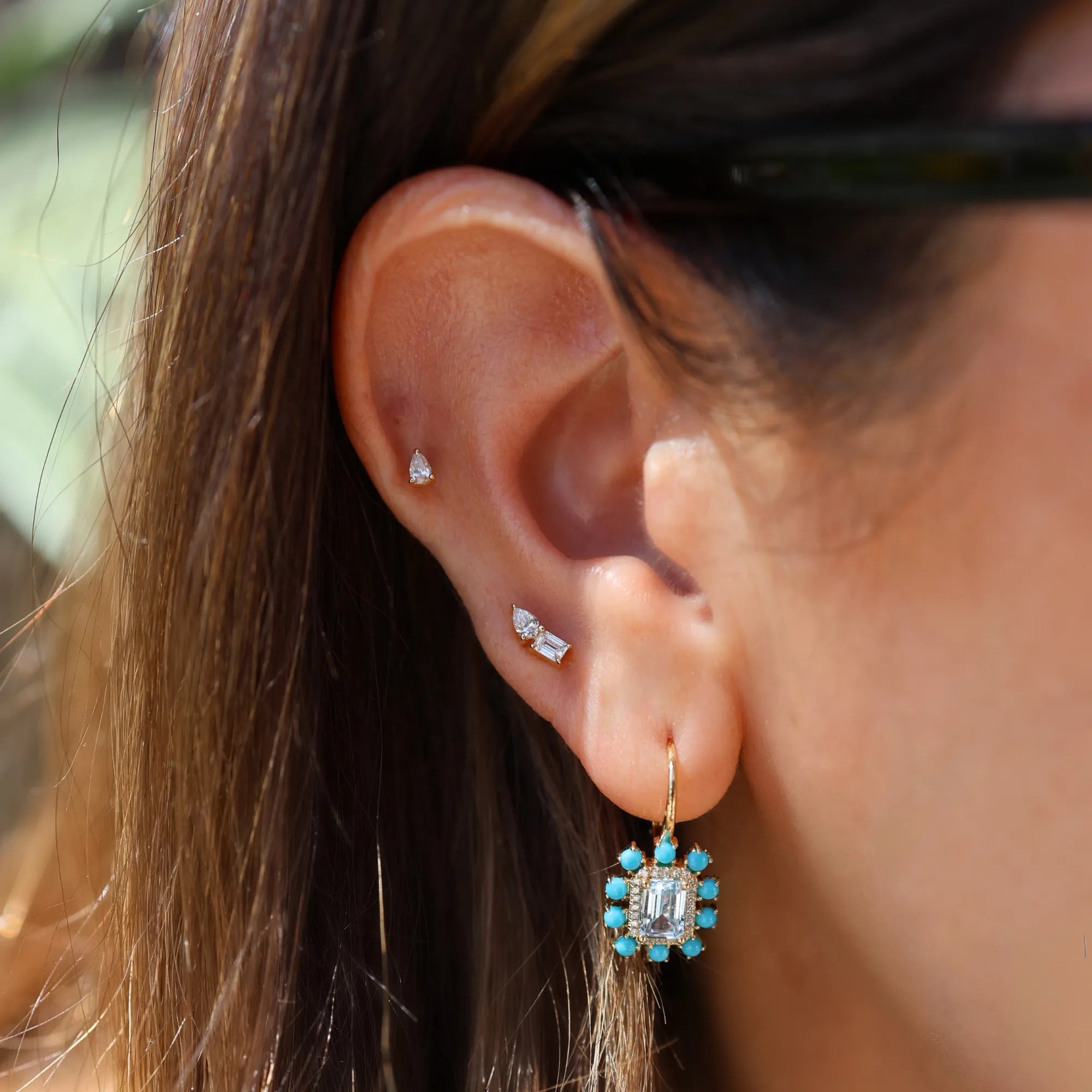 turquoise drop earrings on a woman's ear