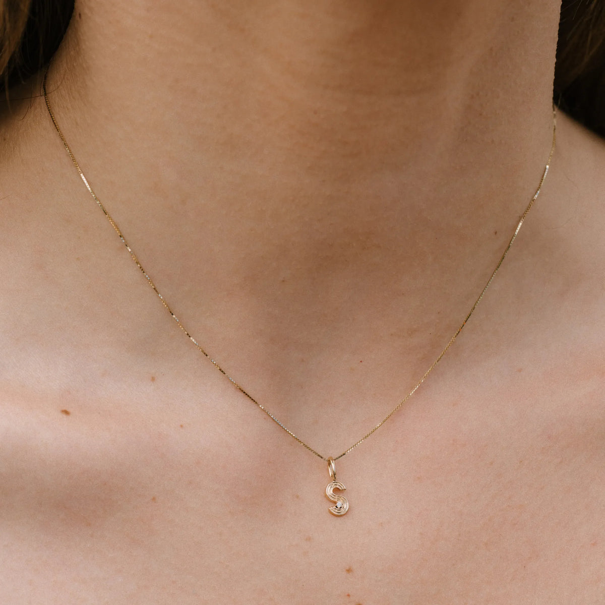 Woman wearing 14k gold dainty box chain necklace, thin layered necklace by Mama Bijoux