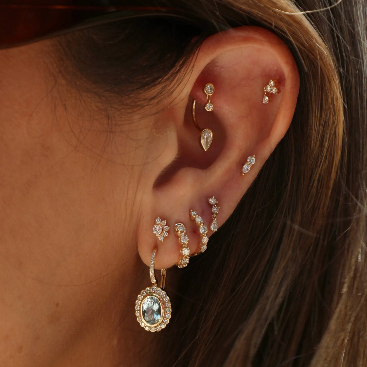 Diamond U hoop earring layered with gold studs in a curated ear look, Mama Bijoux Orange County jewelry