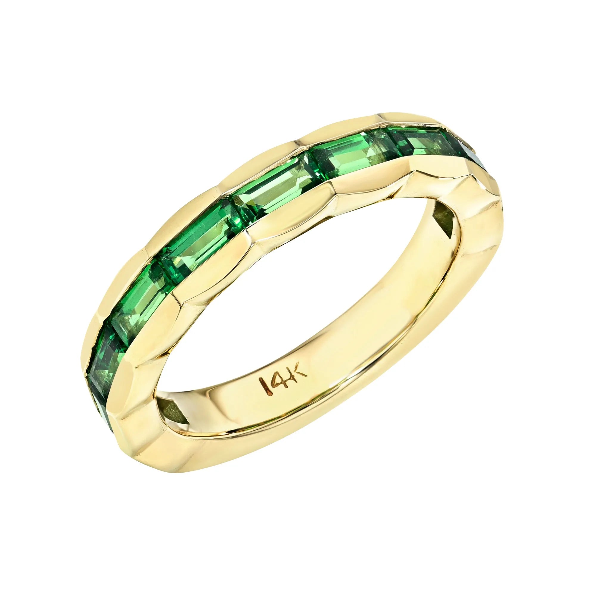Gold ring with green gemstones on a white background