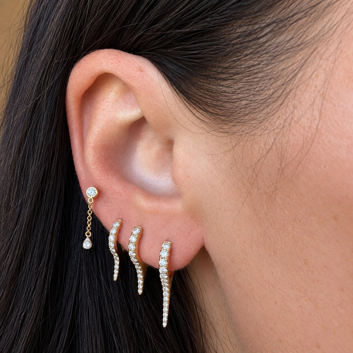 Mini Bijoux Diamond Dagger Huggies worn in an ear stack with a diamond drop stud, Mama Bijoux