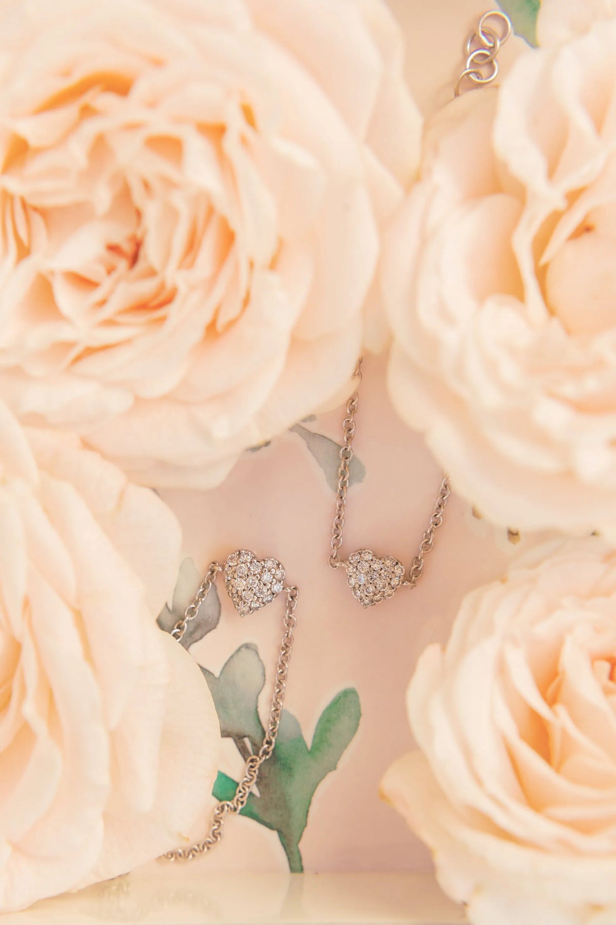 Mom & Babe Matching Diamond Heart Bracelet Set in 18k white gold: adult and baby bracelets among peach roses
