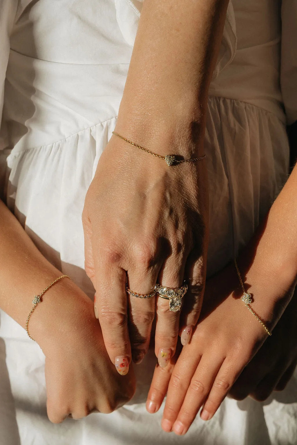 Mom & Babe Matching Diamond Heart Bracelet Set in 18k yellow gold: worn on wrist, mom and child wearing matching bracelets