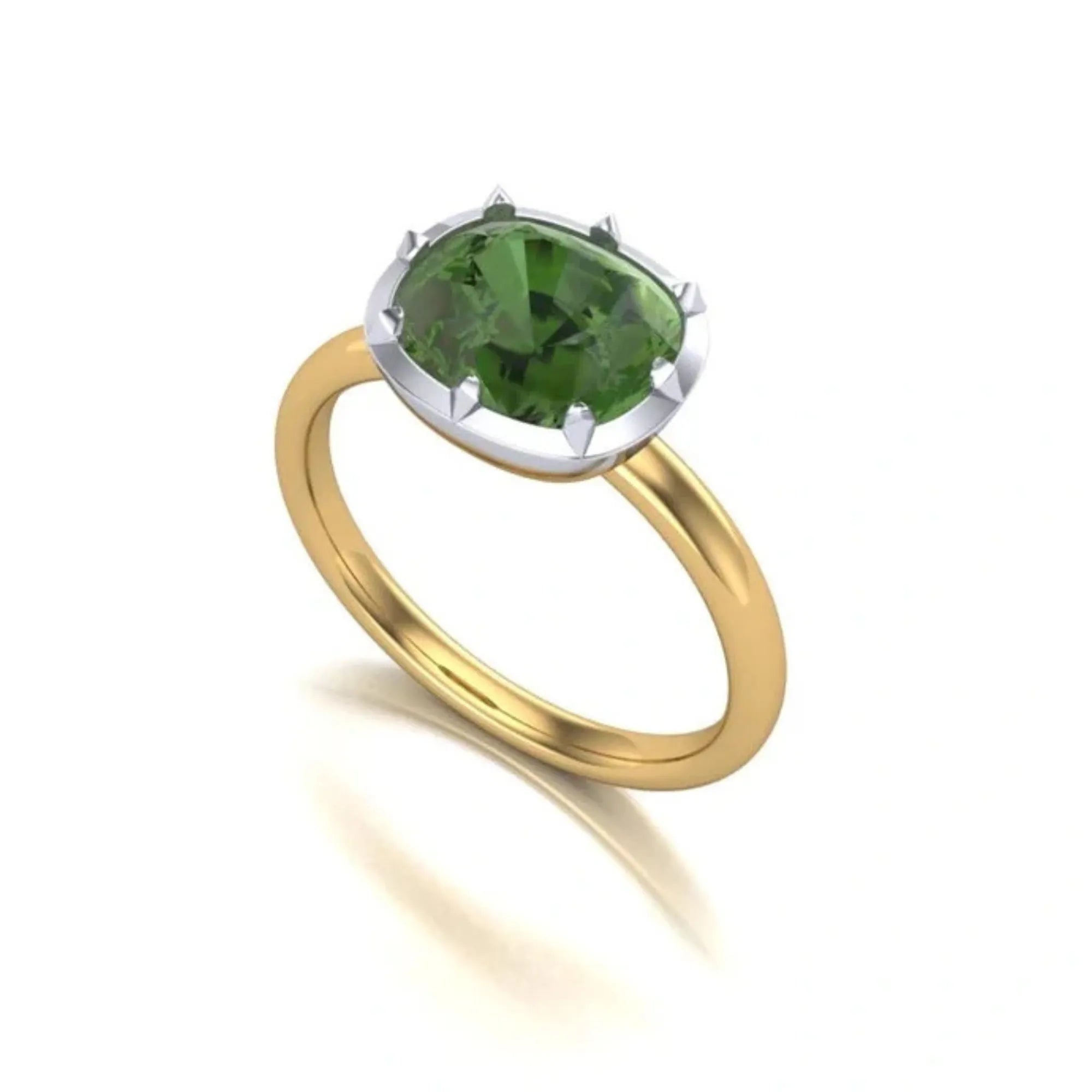 Gold ring with a green gemstone on a white background