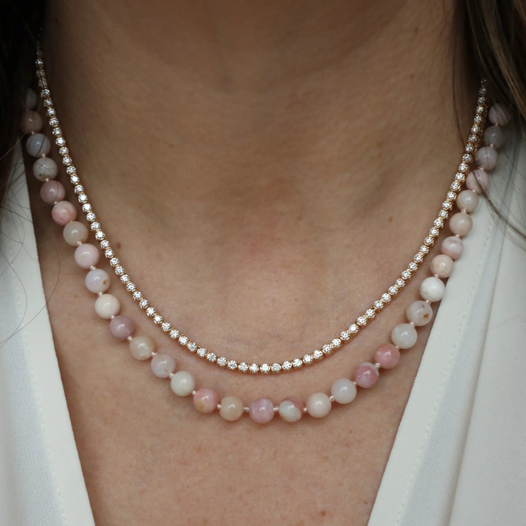 Close-up of an ear wearing gold hoop earrings with a blurred background