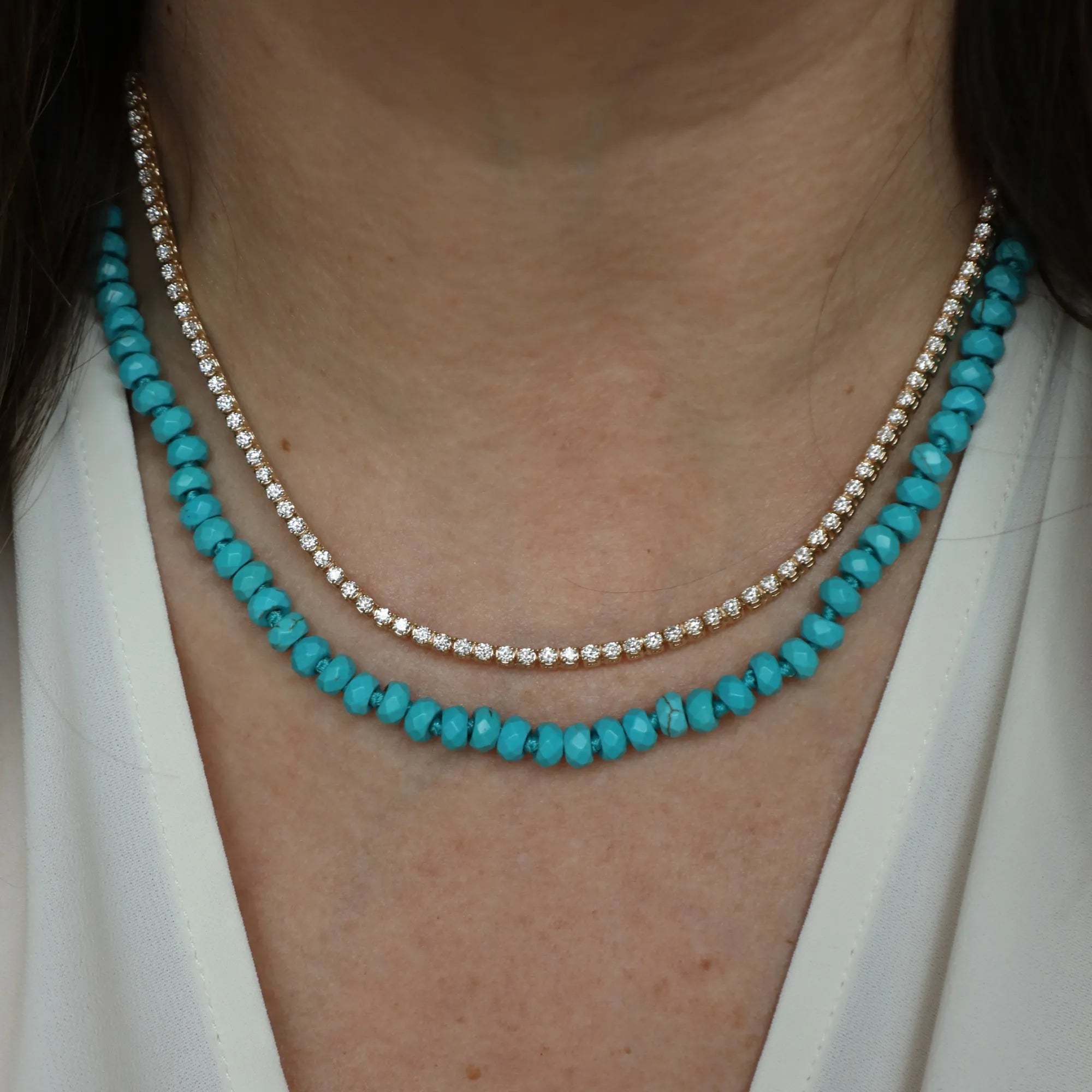 Necklace with small round beads worn by a person
