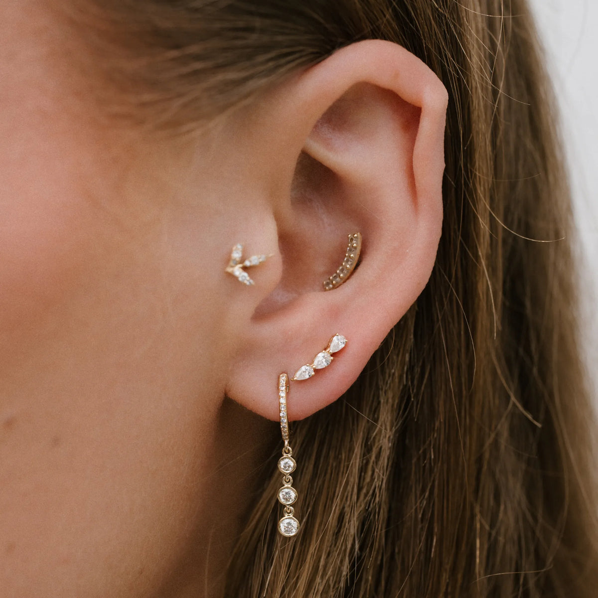 14k yellow gold huggie hoop earrings with three bezel set diamonds, dangly diamond huggies by Mama Bijoux, Costa Mesa Orange County jewelry