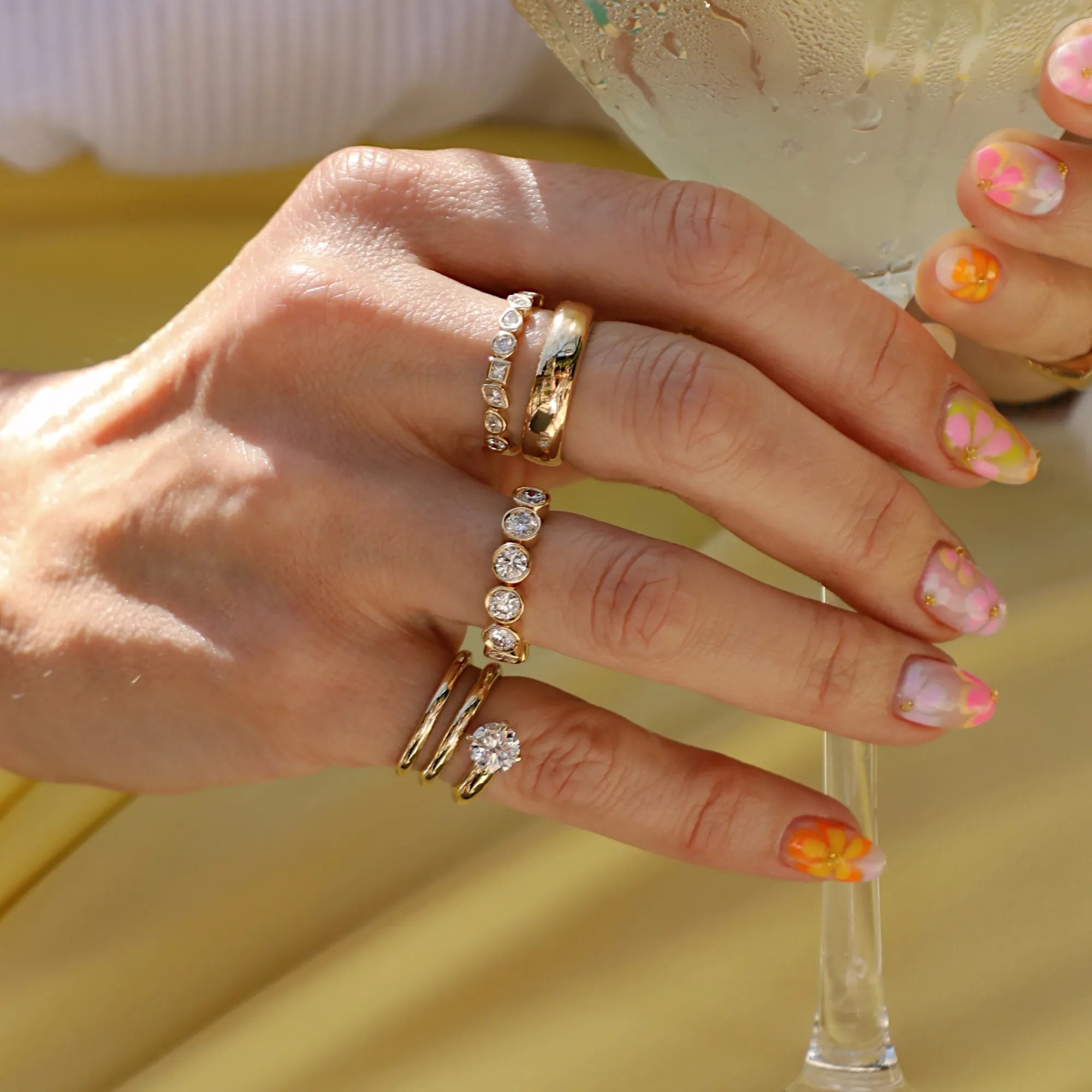 Bezel set diamond stacking rings paired with polished solid gold bands in a modern heirloom jewelry stack featuring minimalist fine jewelry, everyday gold rings, dainty diamond bands, luxury stacking rings, and timeless jewelry designed to be worn daily and passed down for generations.