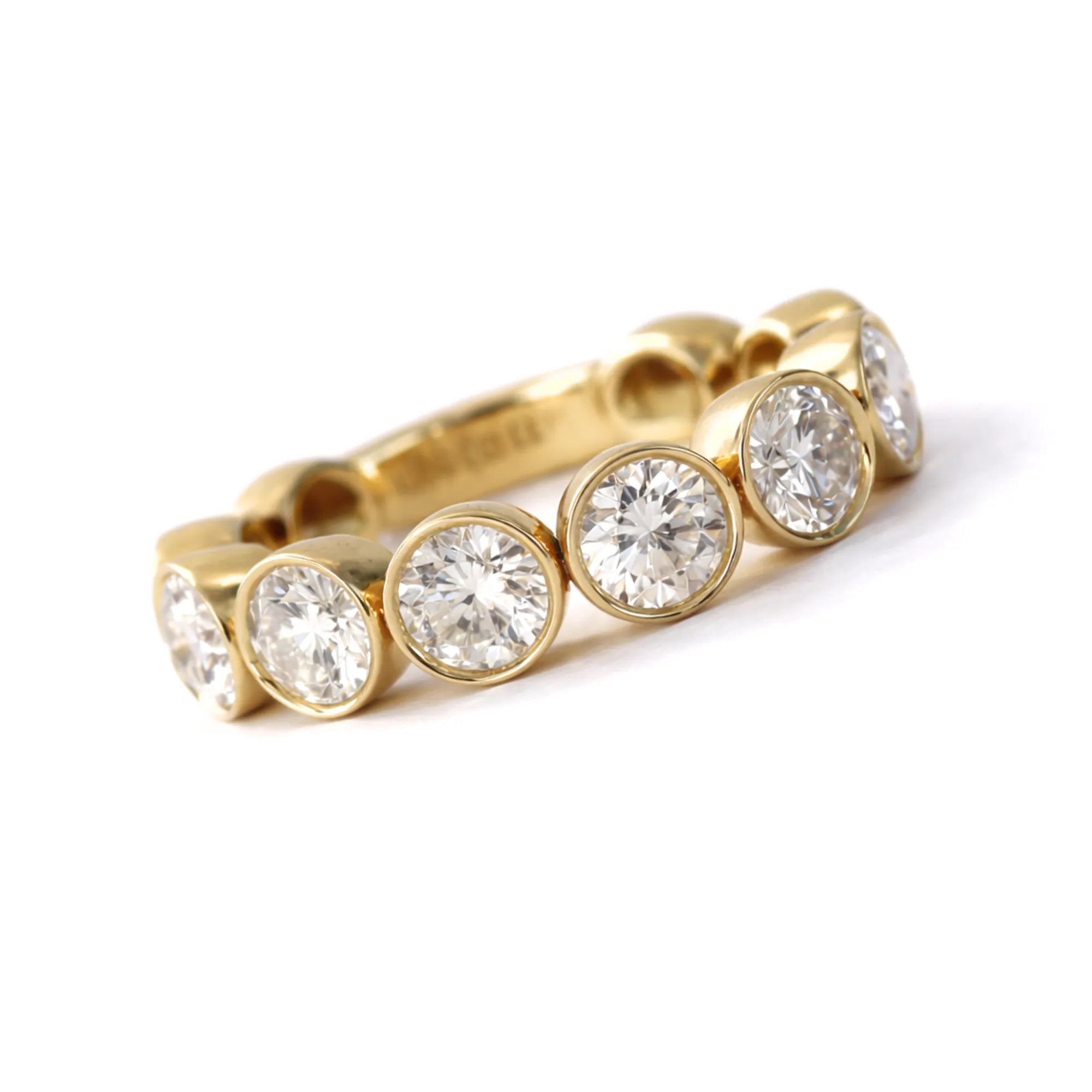 Classic bezel set round lab diamond eternity band ring in 14k yellow gold Mama Bijoux Costa Mesa wedding bands and stacking rings