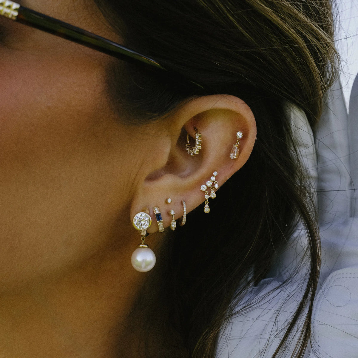 Lab diamond huggie earring with natural pearl drop worn in ear stack, gold huggie earrings by Mama Bijoux Orange County