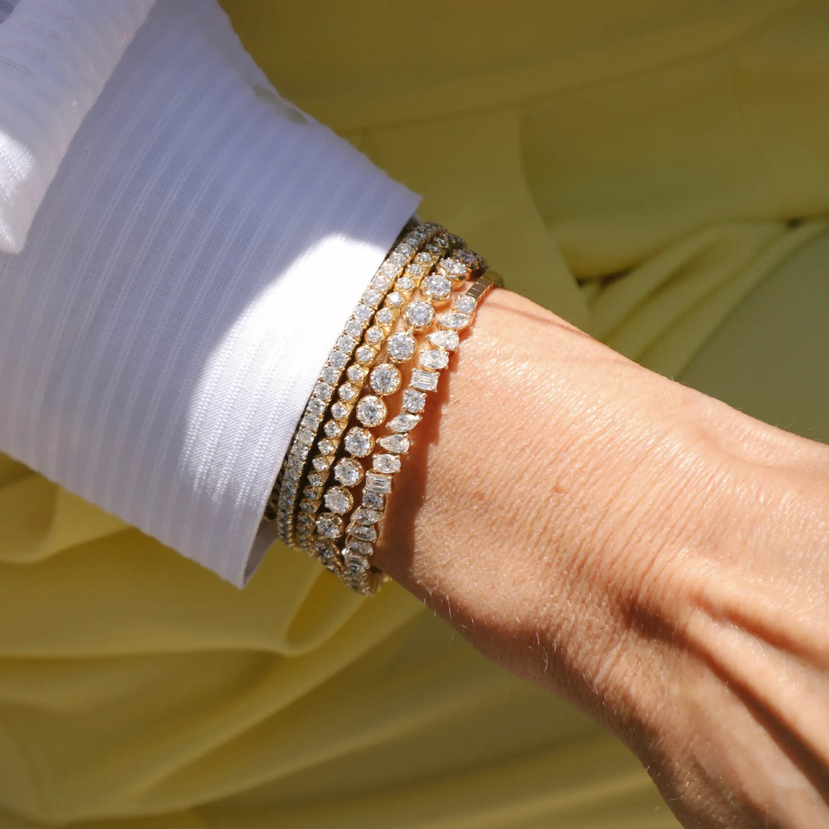 Georgian Riviere Custom Tennis Bracelet stacked on wrist with gold bracelets 14k yellow gold fine diamond bracelet Mama Bijoux Costa Mesa