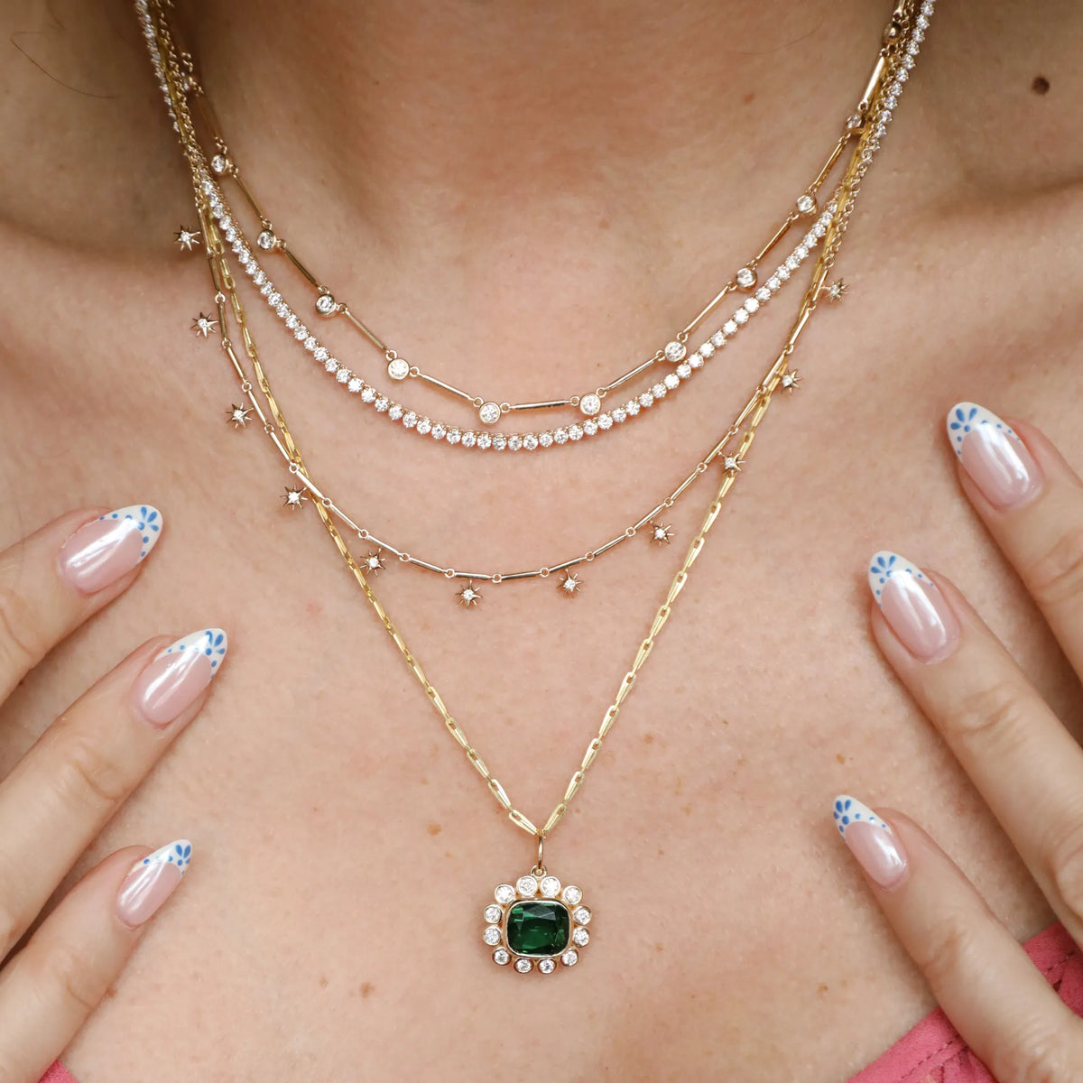 Green tourmaline pendant layered with diamond necklaces and gold chains, layered necklace stack, Orange County fine jewelry