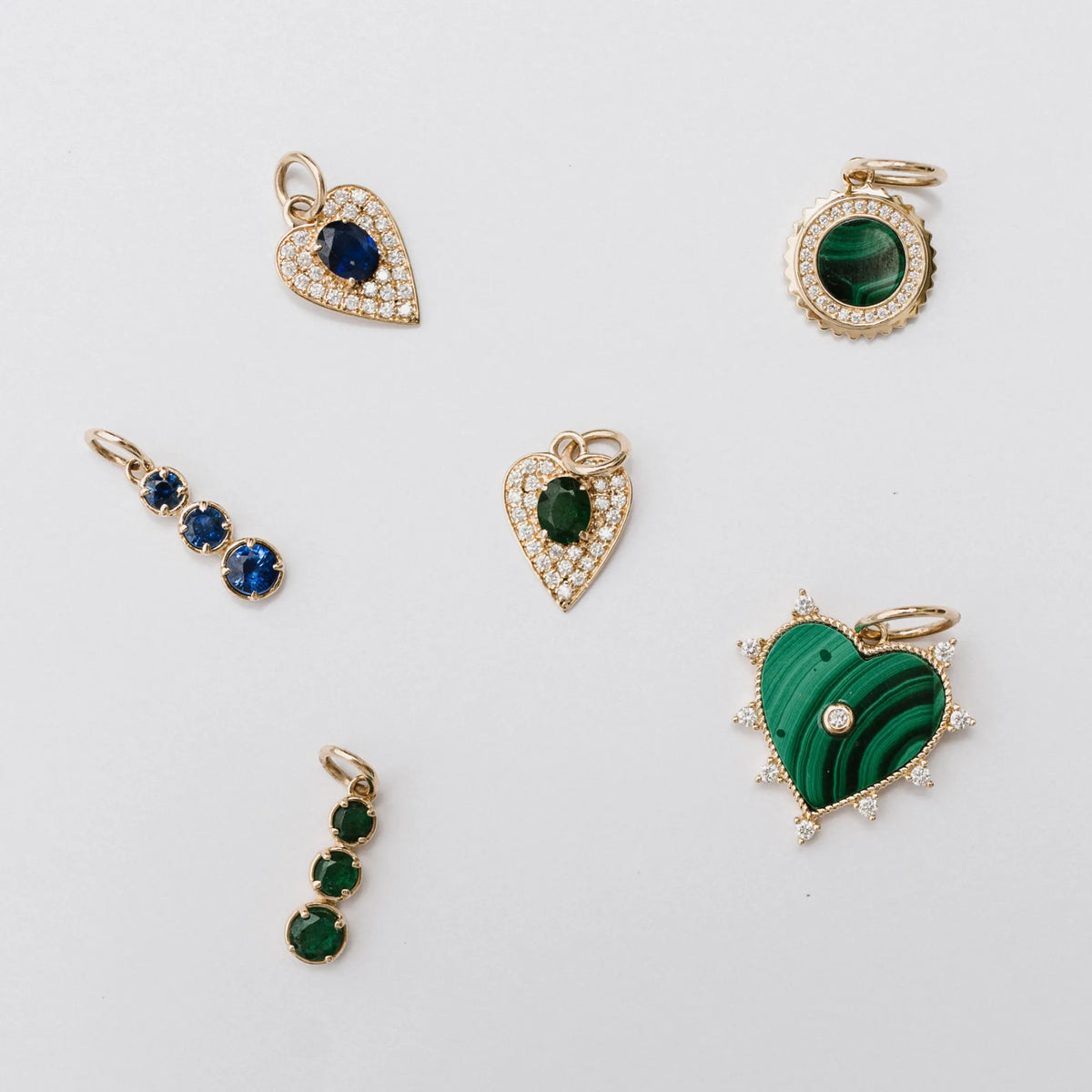 Malachite medallion charm shown in a flat lay with assorted gemstone charms, charm necklace collection by Mama Bijoux Costa Mesa