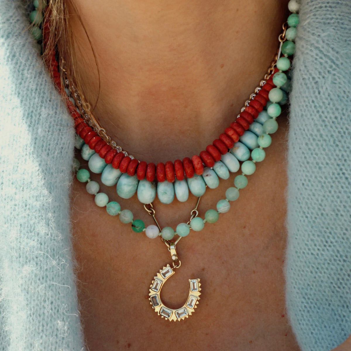 Natural coral beaded necklace layered with turquoise and fine gemstone jewelry for an elevated everyday look