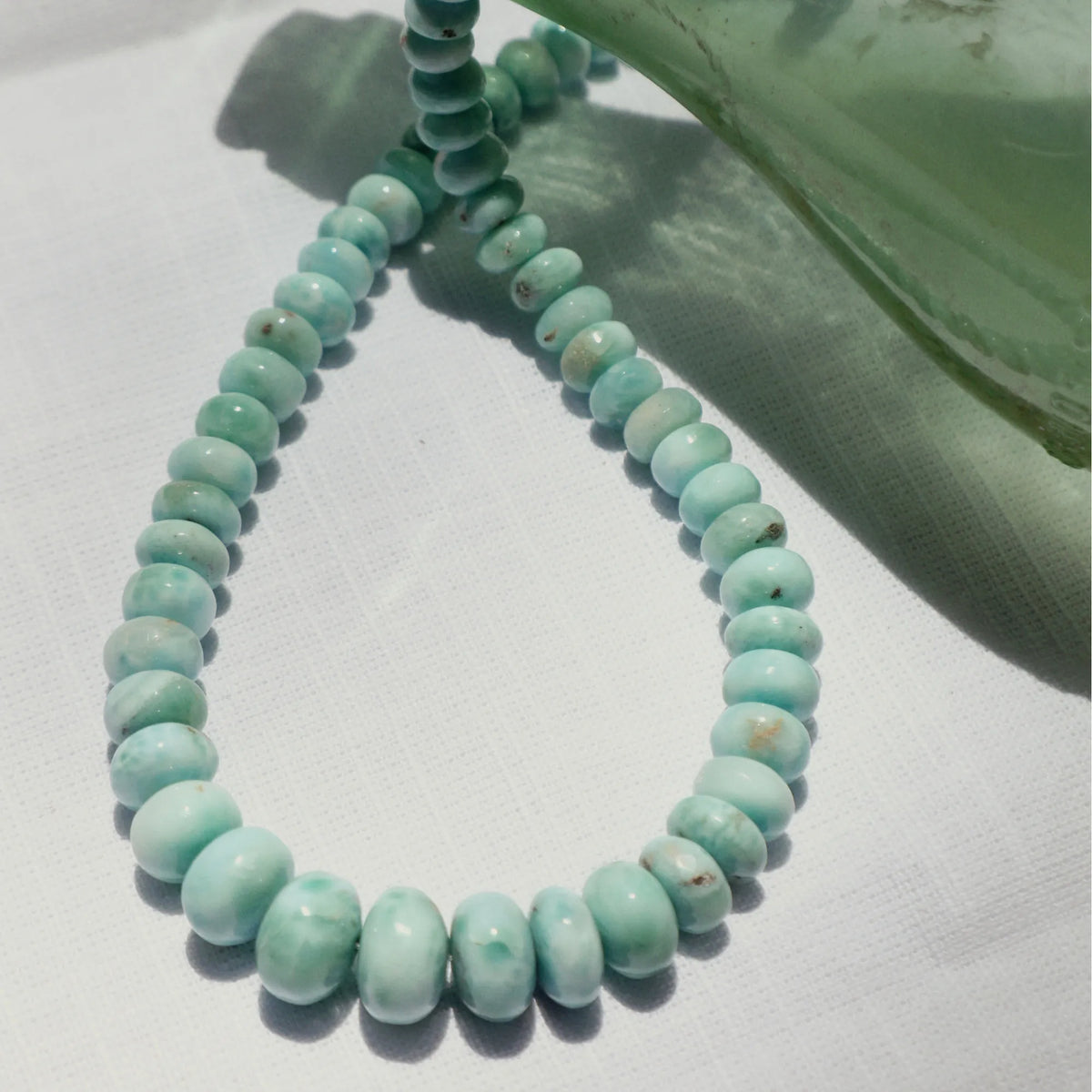 Close-up of natural Larimar beads showing the distinctive blue and white patterning of this rare gemstone