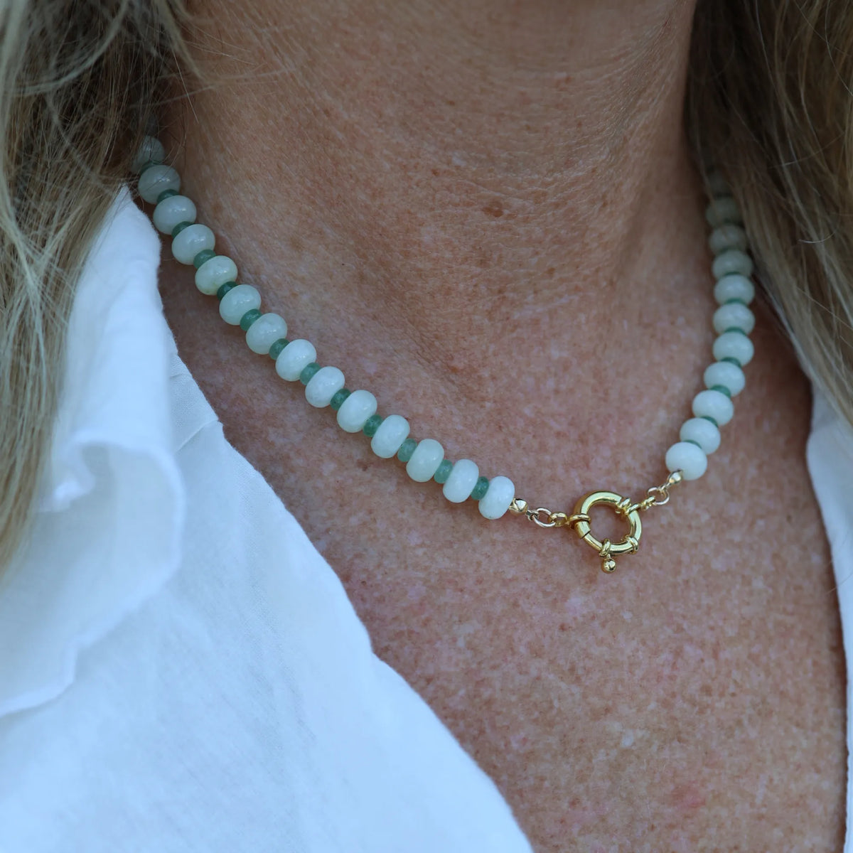 Close-up of the Seafoam Dream necklace by Mama Bijoux x Isla Sol featuring natural prehnite gemstone beads and green aventurine accents for a coastal luxury look.