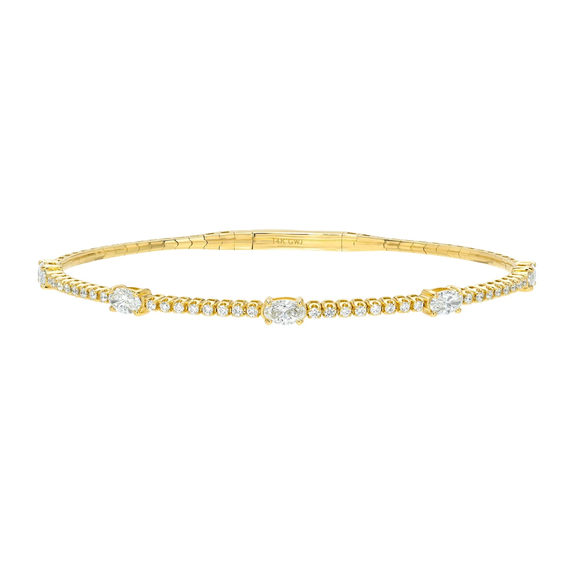 Natural round and lab oval cut diamond flexible bangle in curated wrist stack with diamond tennis bracelet gold chain bracelet and birthstone charms 14k yellow gold Mama Bijoux Costa Mesa
