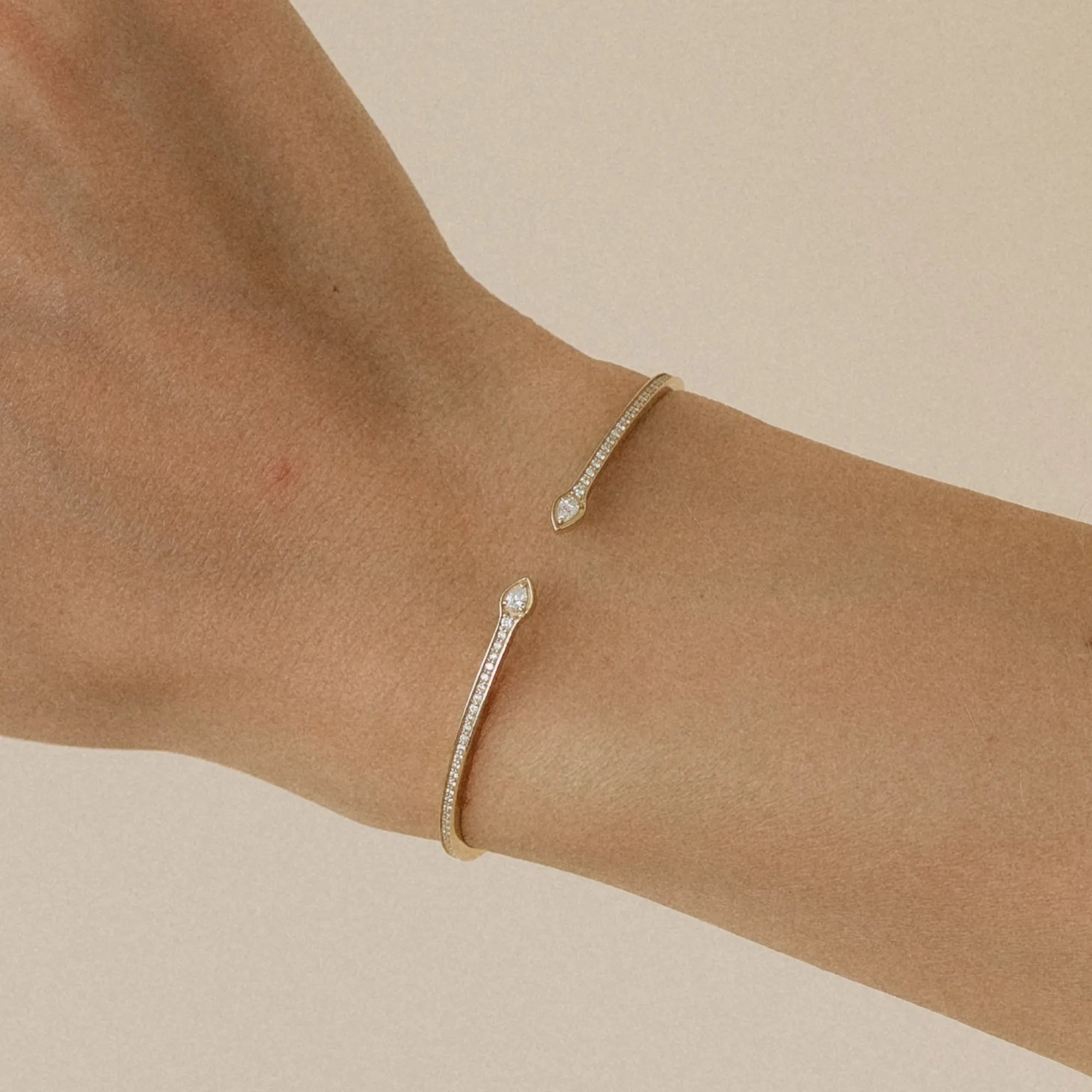 Open cuff pear and round natural diamond bangle bracelet worn on wrist 14k yellow gold Mama Bijoux Costa Mesa