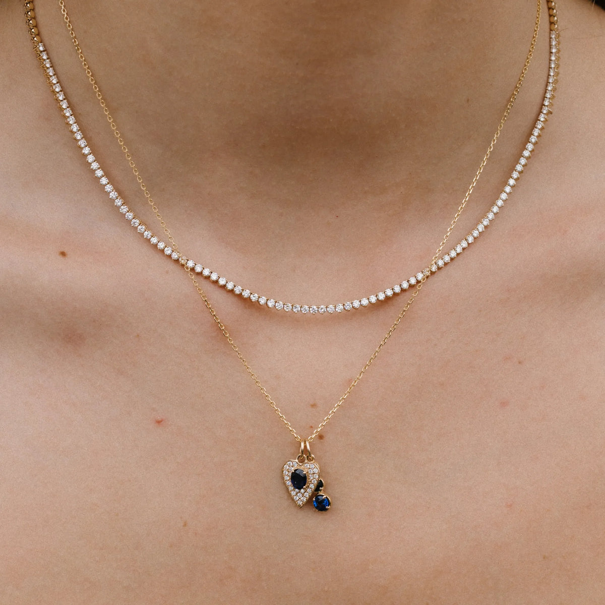 Mini sapphire and diamond pave heart charm necklace worn close up, meaningful jewelry gift by Mama Bijoux Costa Mesa