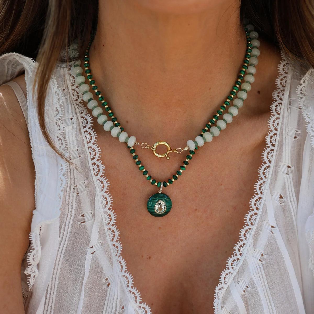 Model wearing the Seafoam Dream necklace by Mama Bijoux x Isla Sol layered with a gold pendant necklace featuring natural prehnite gemstone beads and green aventurine accents.