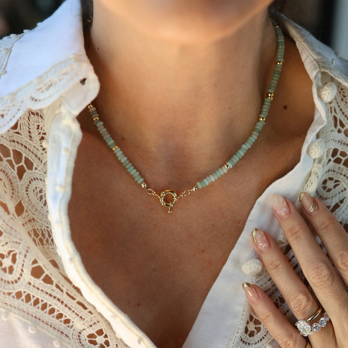 Model wearing the Mama Bijoux x Isla Sol So Shellegant Amazonite Beaded Necklace layered with fine gold necklaces.