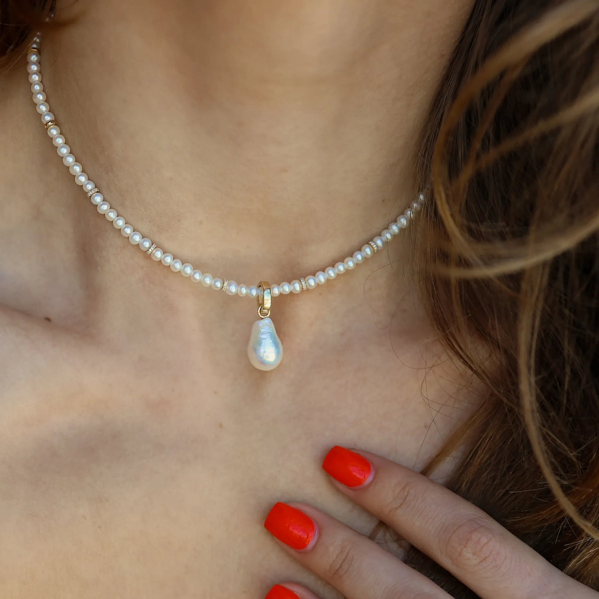 White freshwater pearl necklace with diamond pave gold bead accents and baroque pearl drop charm in 14k gold worn on neck Mama Bijoux Costa Mesa fine jewelry