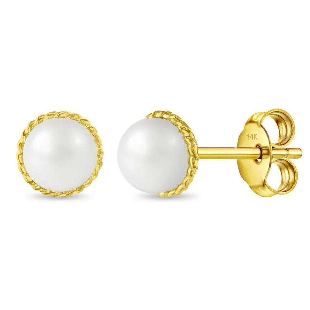 Gold earrings with white pearls on a white background
