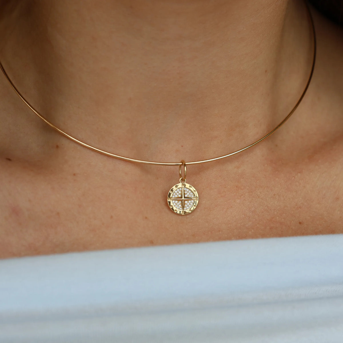 14k yellow gold pavé diamond compass charm necklace worn close on the collarbone, dainty layering pendant from Mama Bijoux fine jewelry, Costa Mesa California