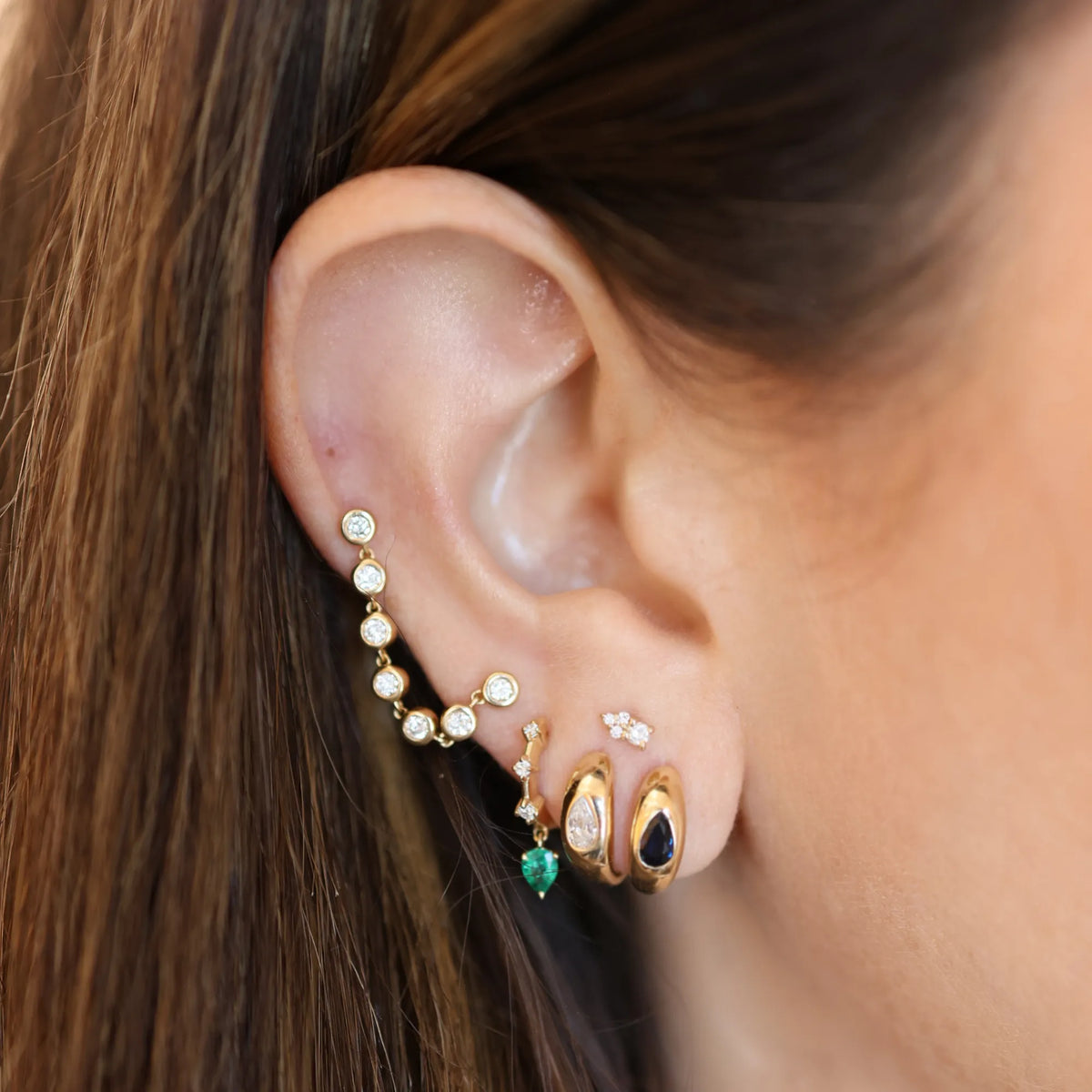 14k yellow gold ear stack featuring huggie hoops, diamond drop earring, and stud earrings, handmade fine jewelry by Mama Bijoux Costa Mesa Orange County