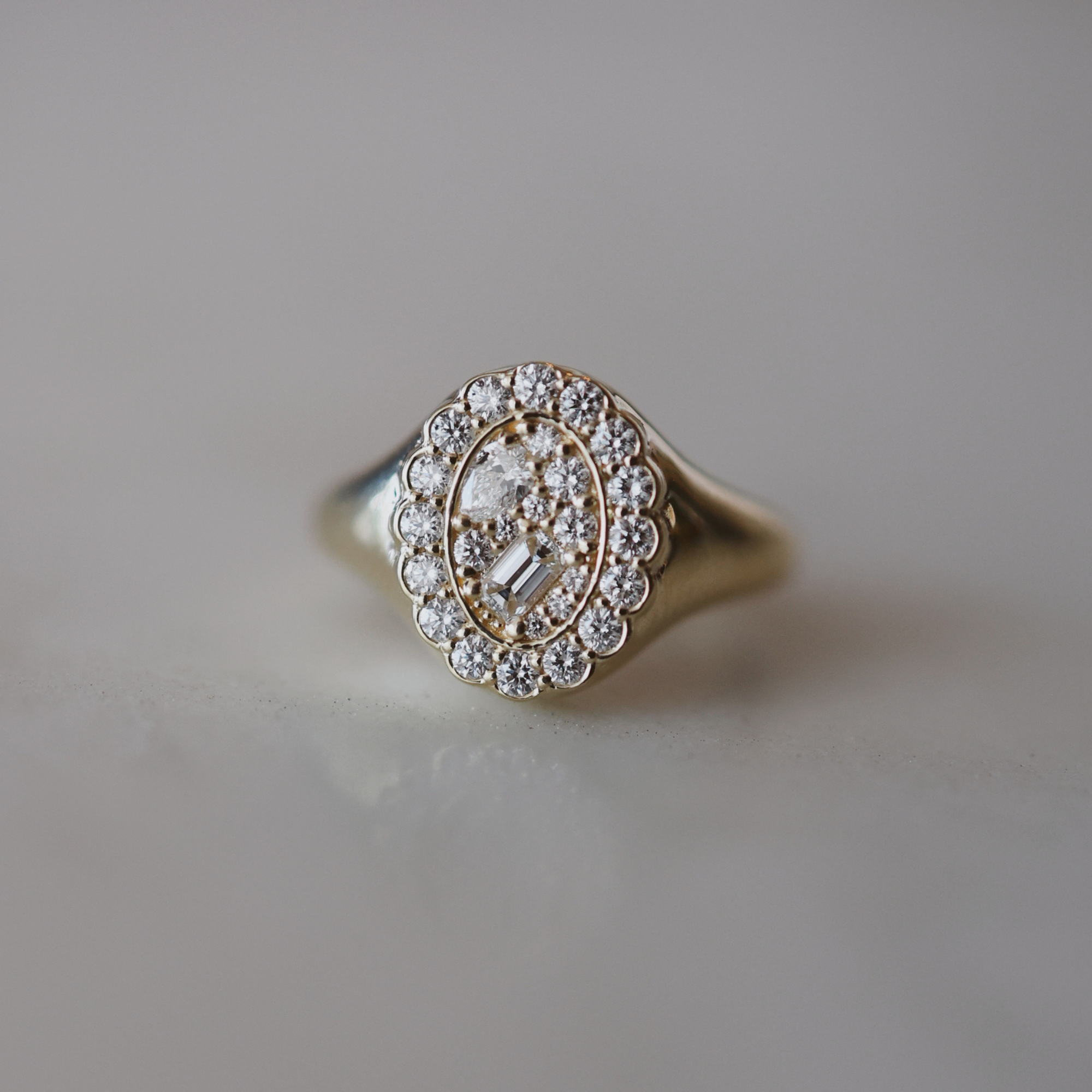 diamond signet ring on a white background