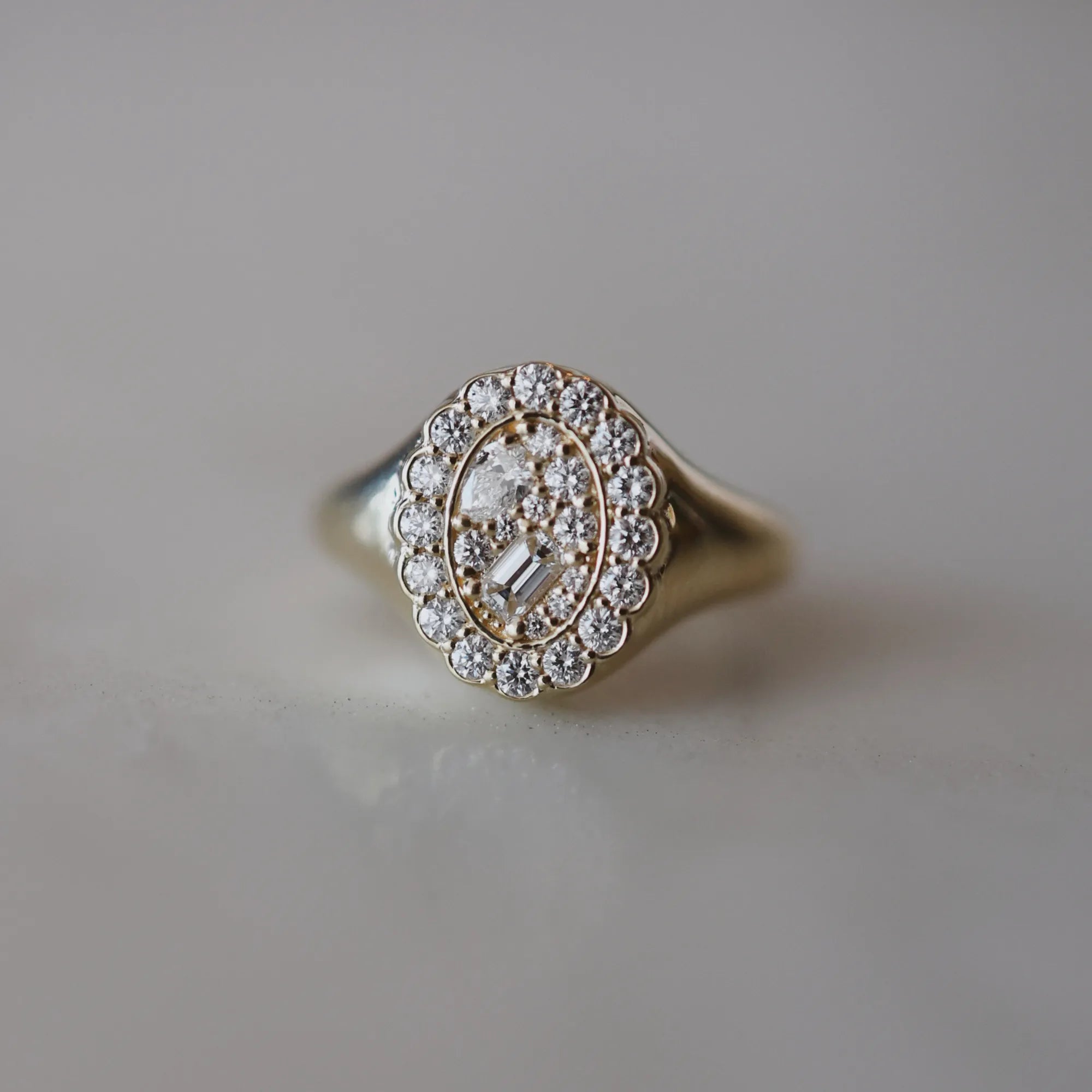 diamond signet ring on a white background
