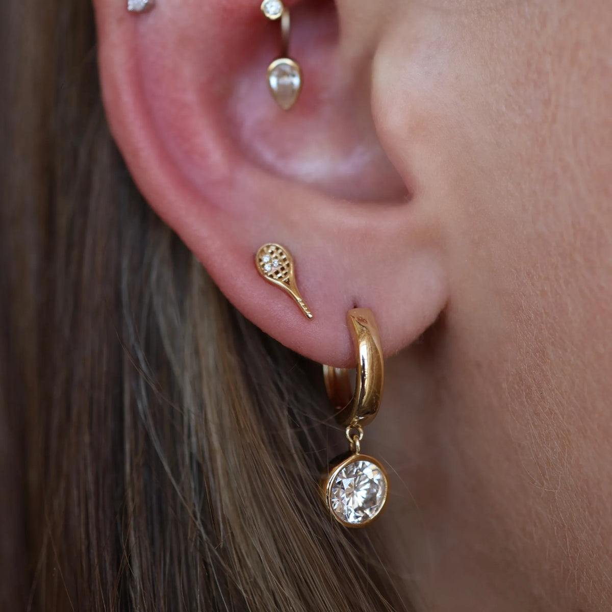 Diamond stud earrings styled in a layered ear stack with gold hoop earrings, 14k yellow gold, Mama Bijoux Costa Mesa Orange County jewelry