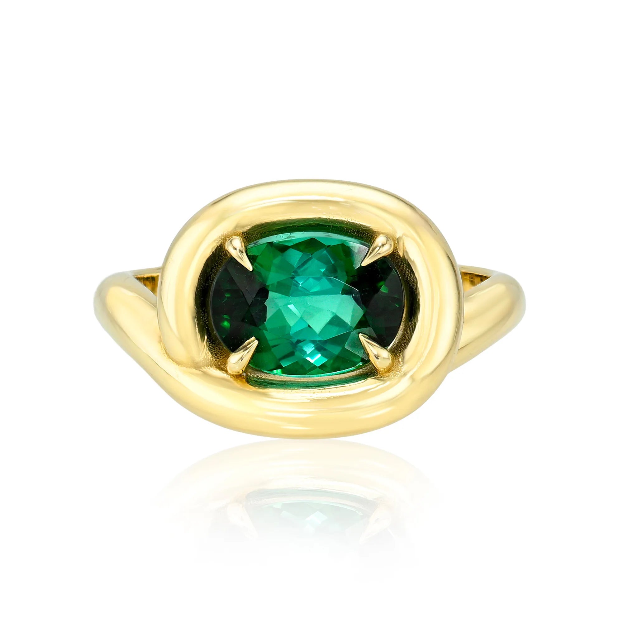 Gold ring with a green gemstone on a white background