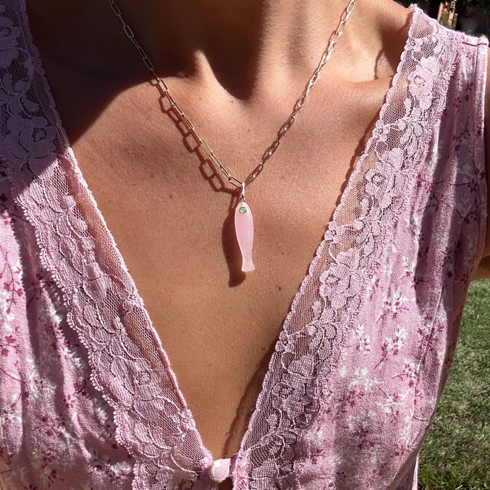 Gold ring with diamonds on a person's finger against a white background