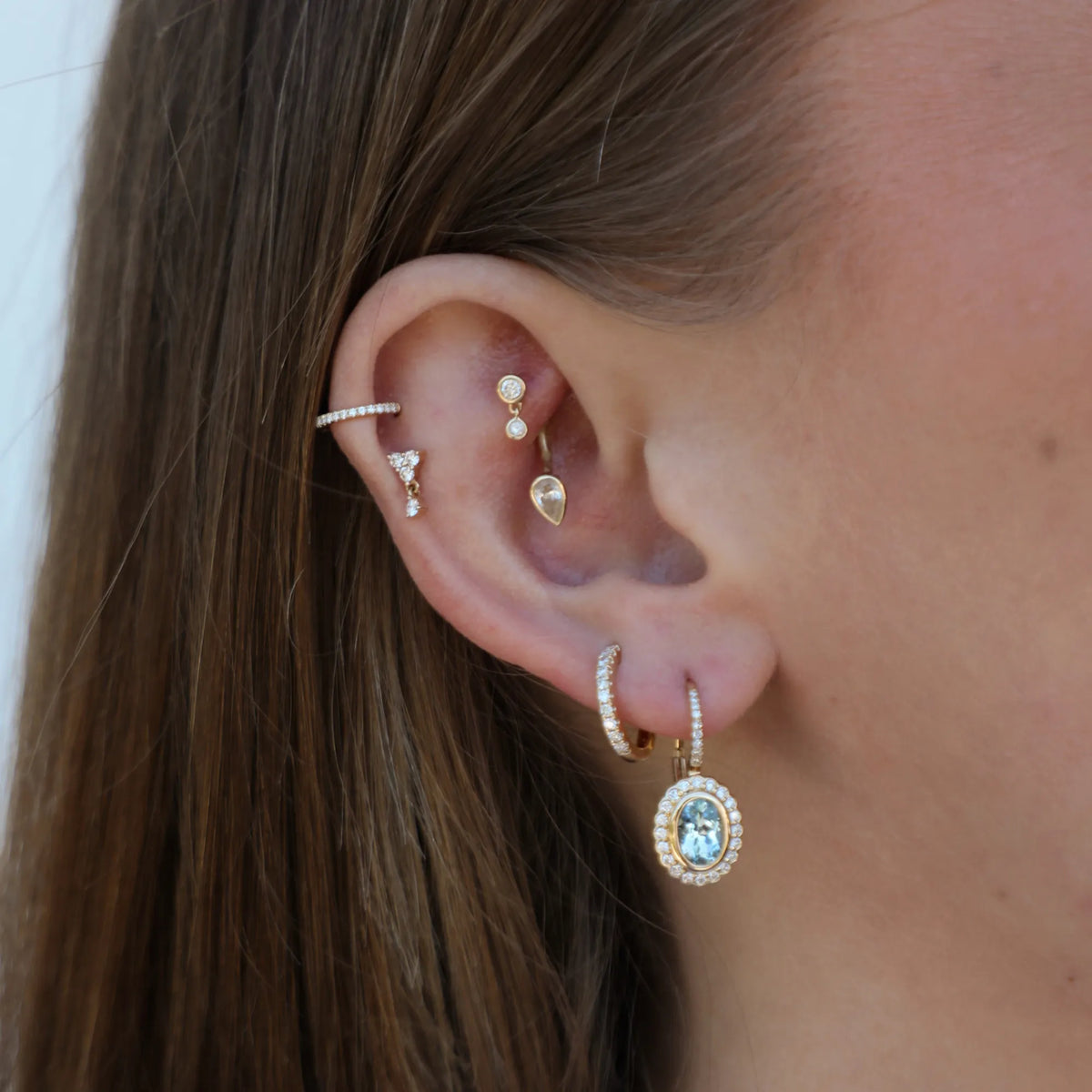 14k gold diamond U hoop earring styled in a layered ear stack, Mama Bijoux Costa Mesa jewelry