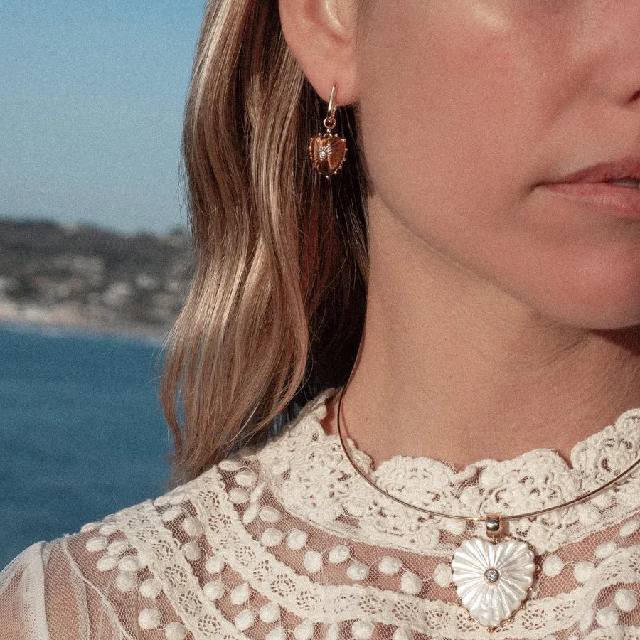 Close-up of Isabel tiger's eye heart charm and removable hoop earring detail
