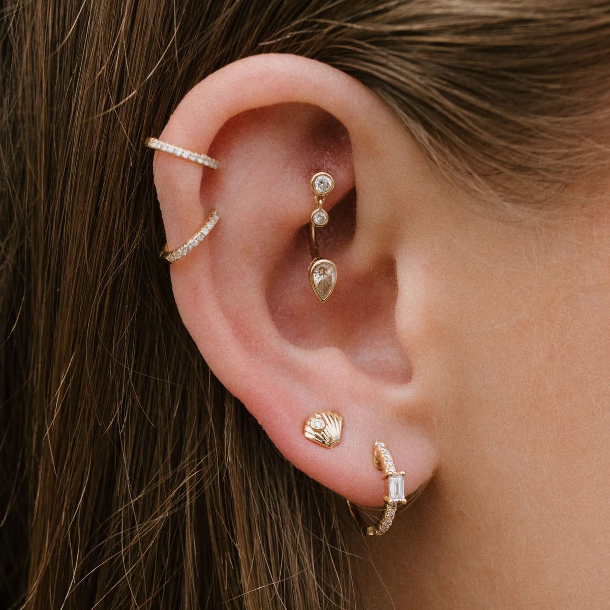 Single Baguette & Diamond Pavé Huggies worn on ear in a curated ear stack mama bijoux costa mesa newport beach jeweler