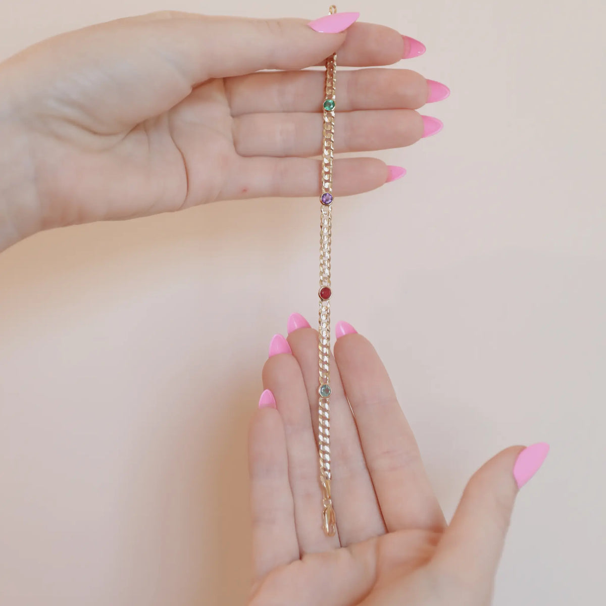 Close up of bezel set natural birthstones on a 14k yellow gold curb chain bracelet, Mama Bijoux Costa Mesa