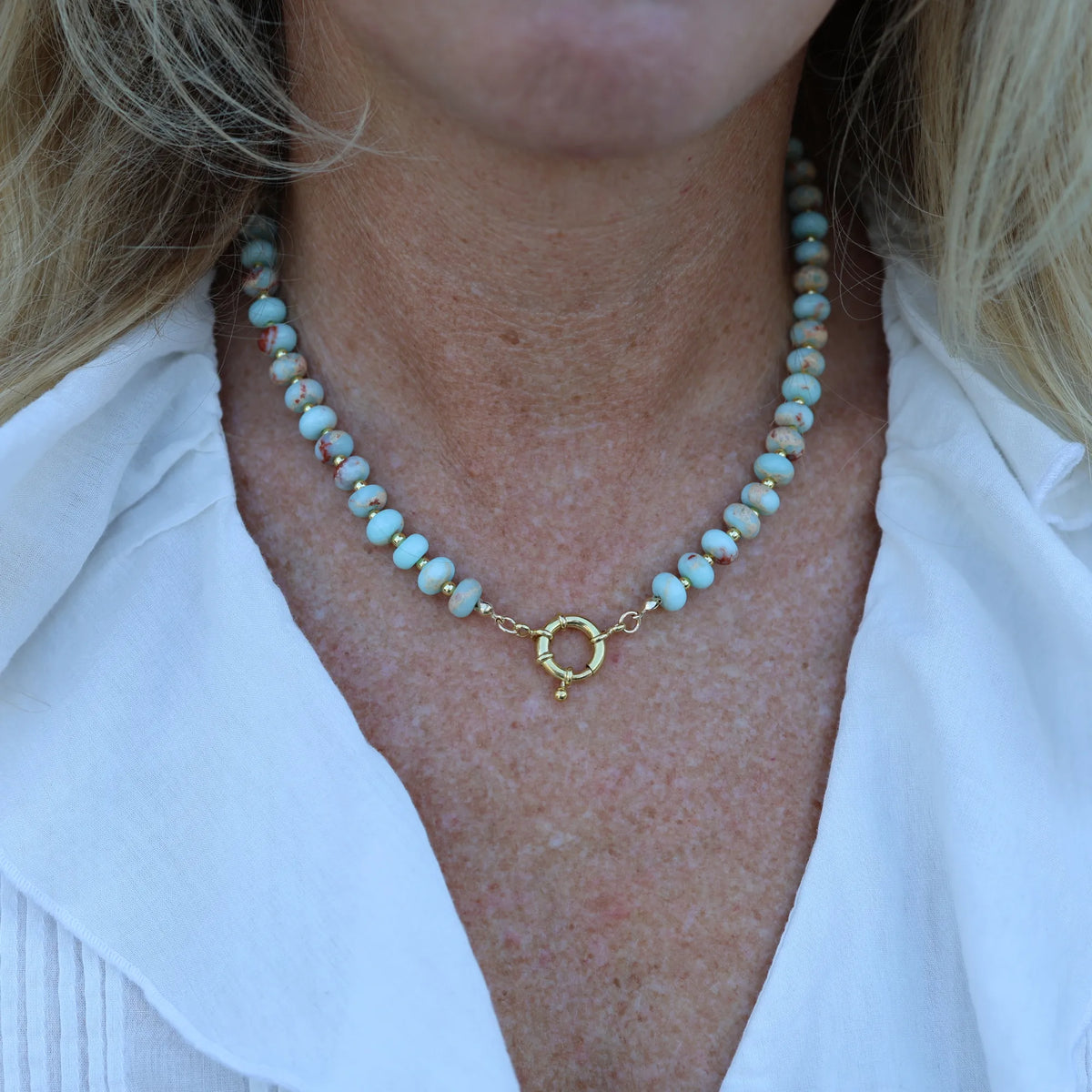 Model wearing the Desert Rose beaded necklace by Mama Bijoux x Isla Sol, a handcrafted natural gemstone necklace with 18k gold spacers inspired by coastal style.