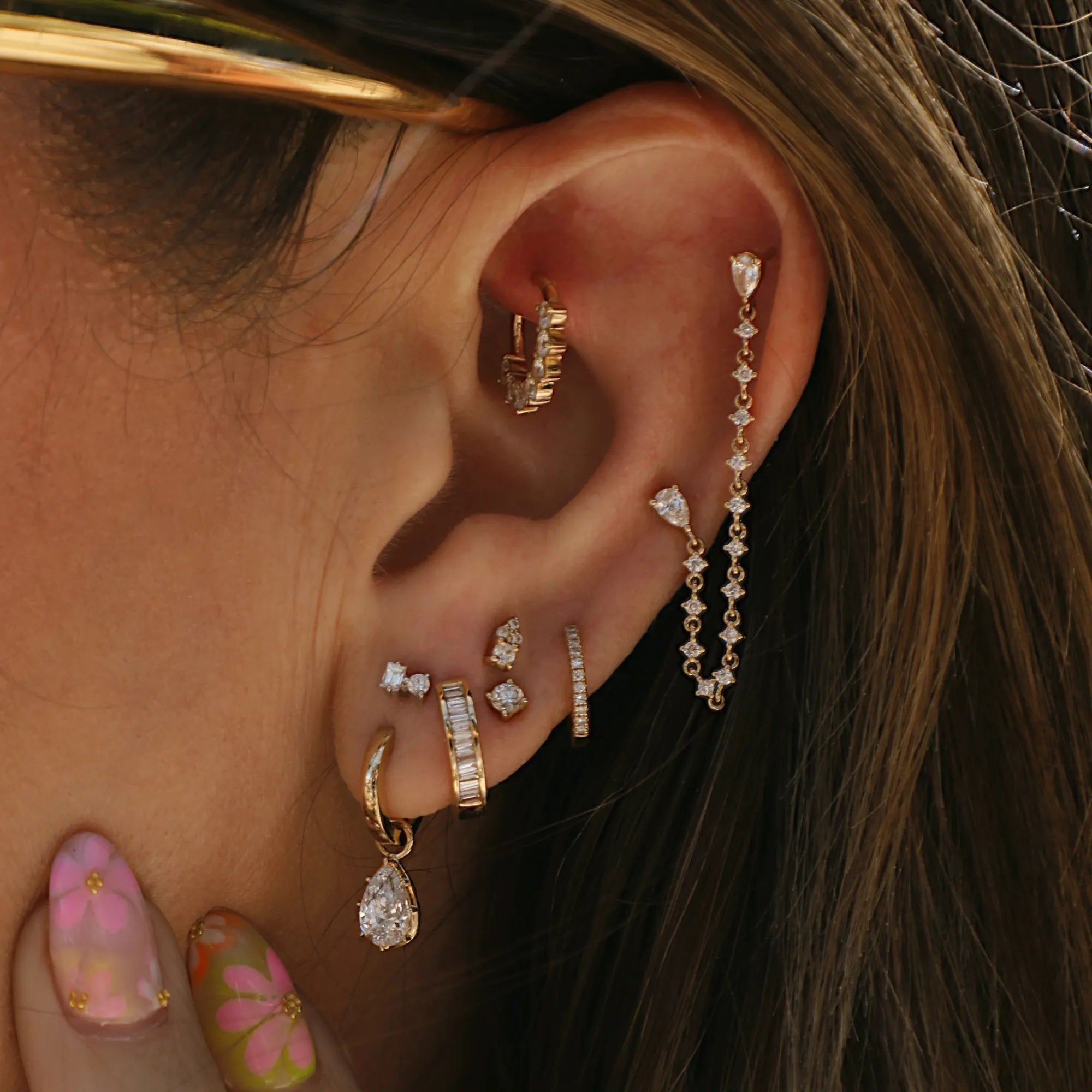 14k gold diamond ear climber and chain earrings styled in a modern minimalist luxury ear stack.