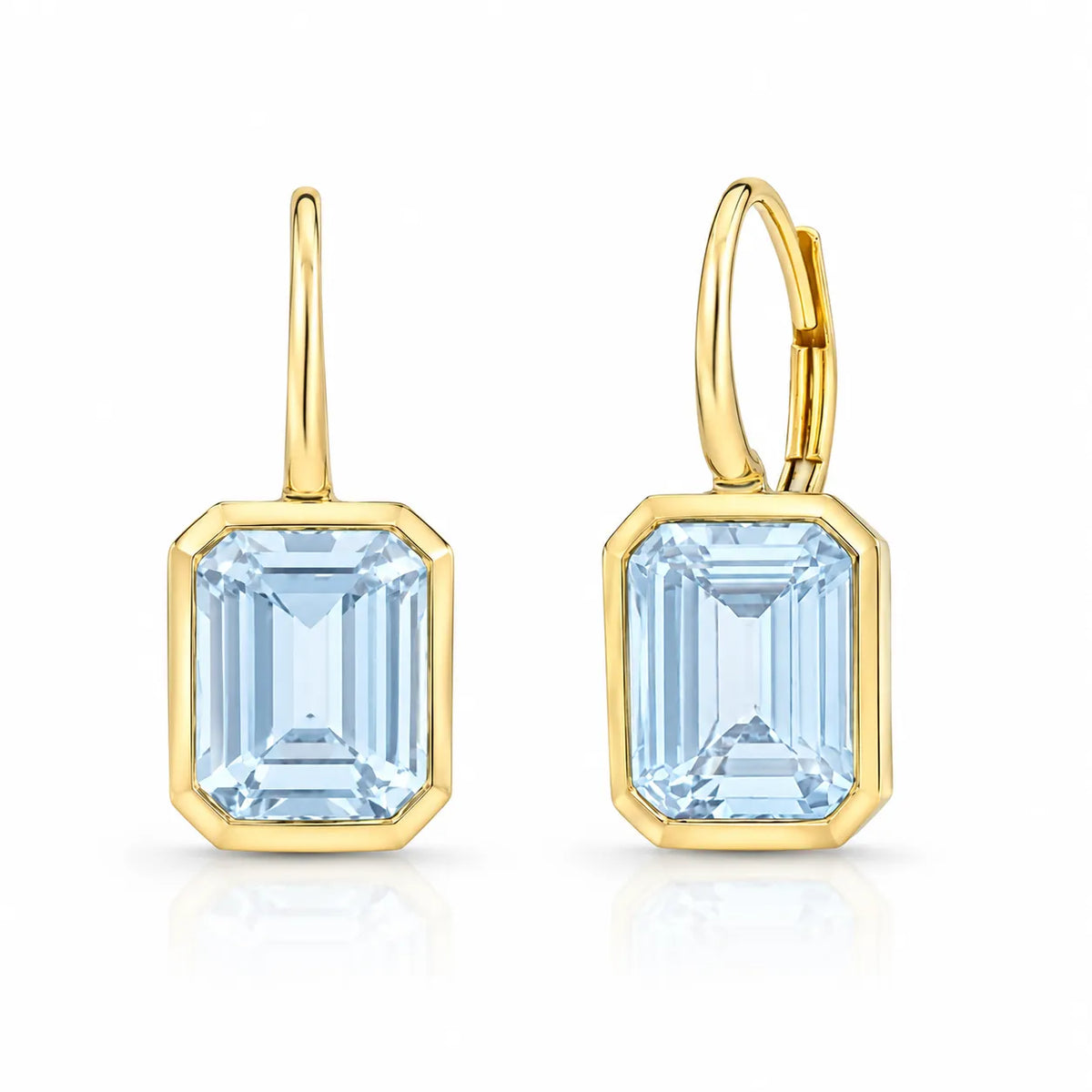 Emerald cut blue topaz bezel drop earrings in fine jewelry, featuring luminous faceted gemstones and a refined gold setting