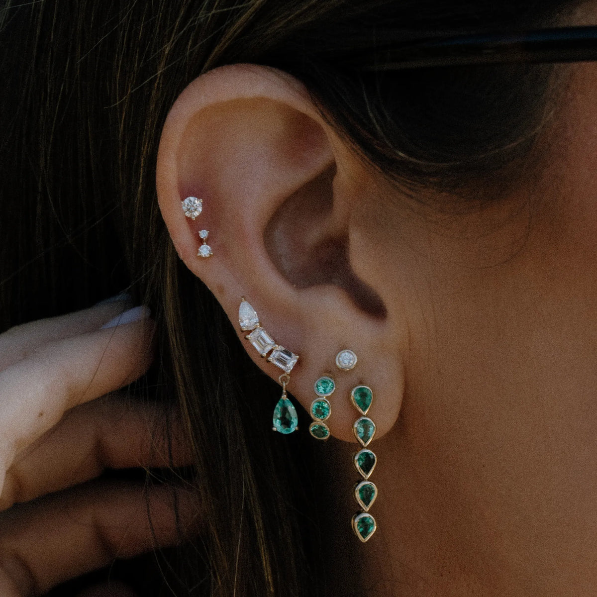 Three diamond and emerald pear statement crawler worn along the ear with stud stack, statement earrings by Mama Bijoux Orange County