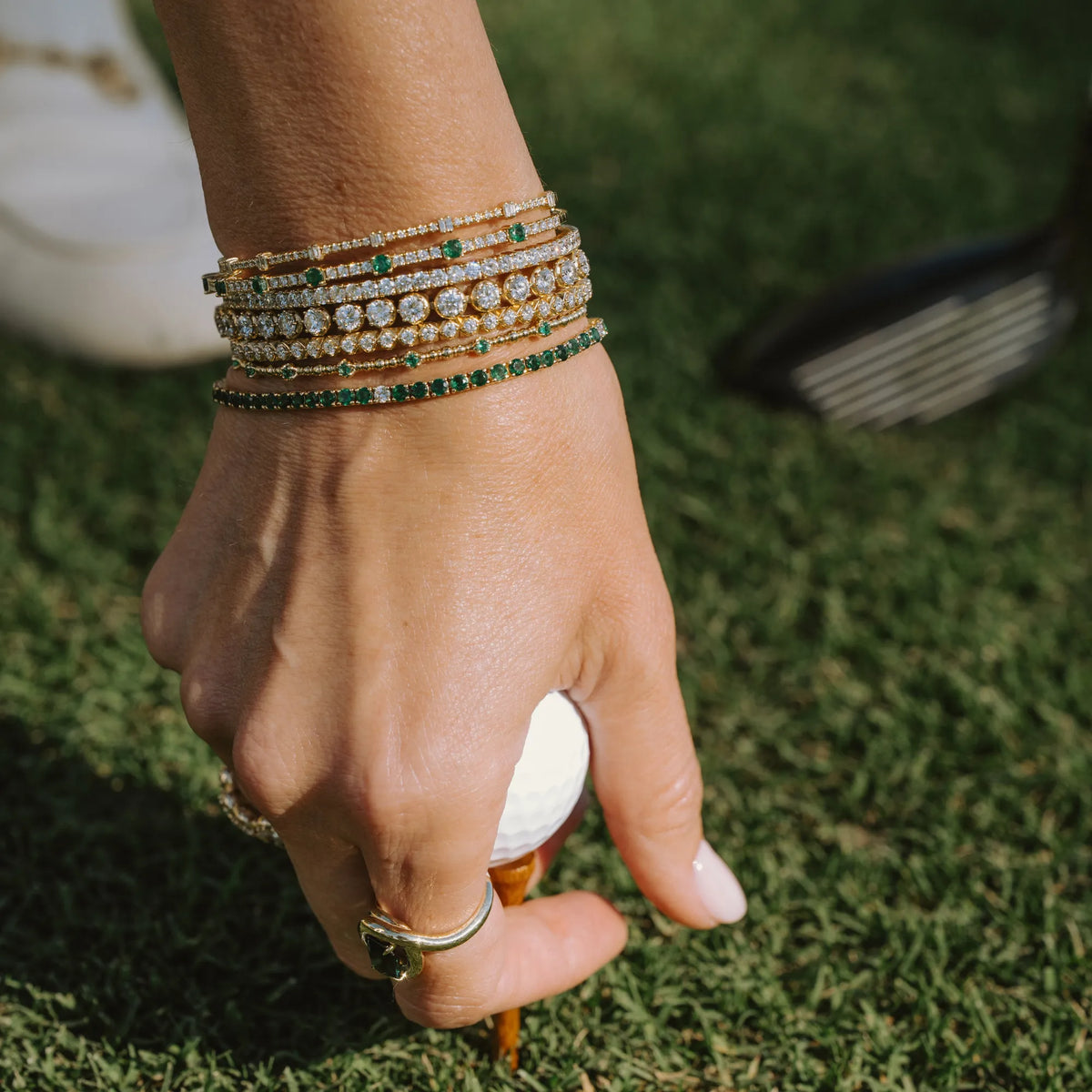 14k yellow gold emerald diamond tennis bracelet worn outdoors, everyday luxury jewelry by Mama Bijoux Costa Mesa