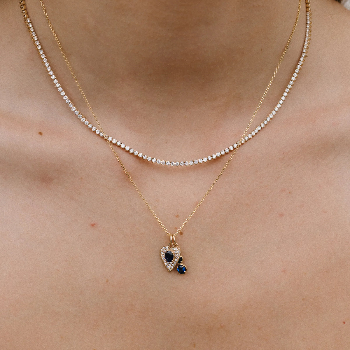14k yellow gold necklace with graduated blue sapphire drop charm worn close up, dainty necklace by Mama Bijoux Costa Mesa