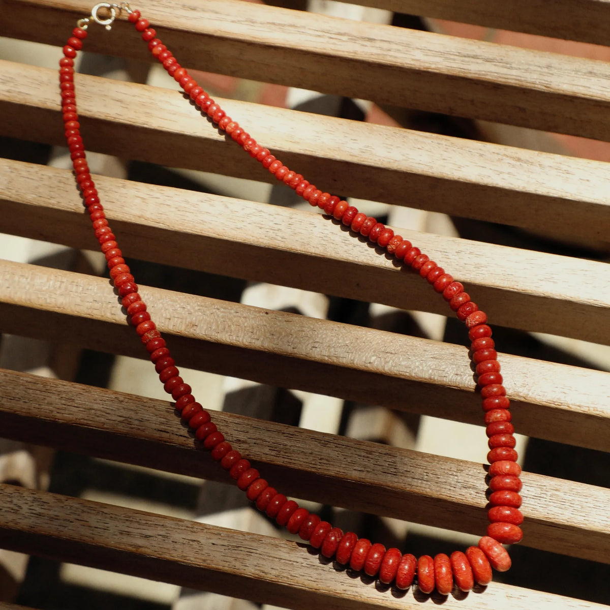 Natural coral graduated beaded necklace styled as a distinctive statement piece of fine jewelry